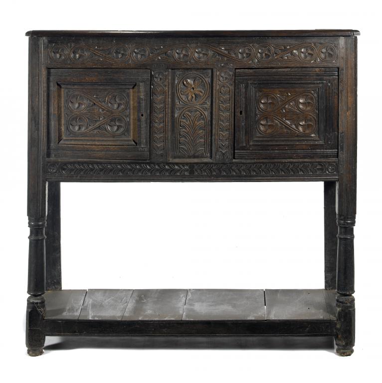 Appraisal: A CHARLES II JOINED OAK LIVERY CUPBOARD the panelled front