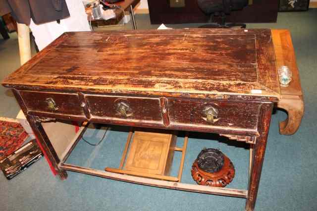 Appraisal: A CHINESE PROVINCIAL STAINED ELM SIDE TABLE fitted three drawers