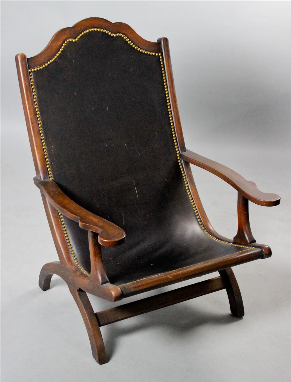 Appraisal: COLONIAL STYLE MAHOGANY AND LEATHER CAMPECHE LOUNGE CHAIR having a