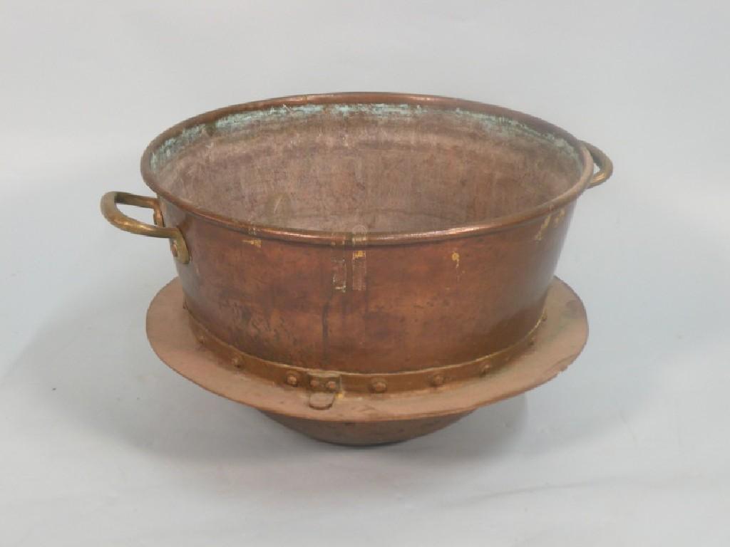 Appraisal: A large copper and brass pan with a broad rim