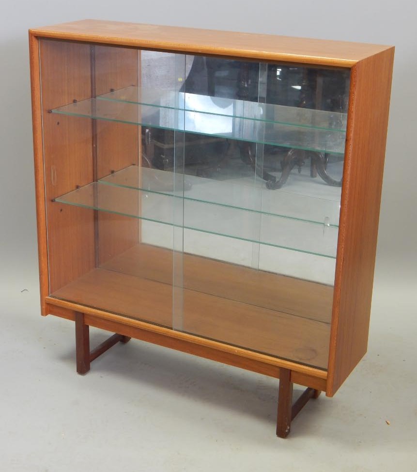 Appraisal: A Retro style teak bookcase with two sliding doors enclosing