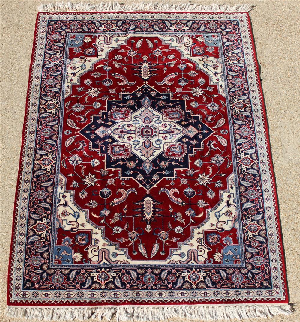 Appraisal: INDO-PERSIAN HERIZ DESIGN RUG central medallion on a red field