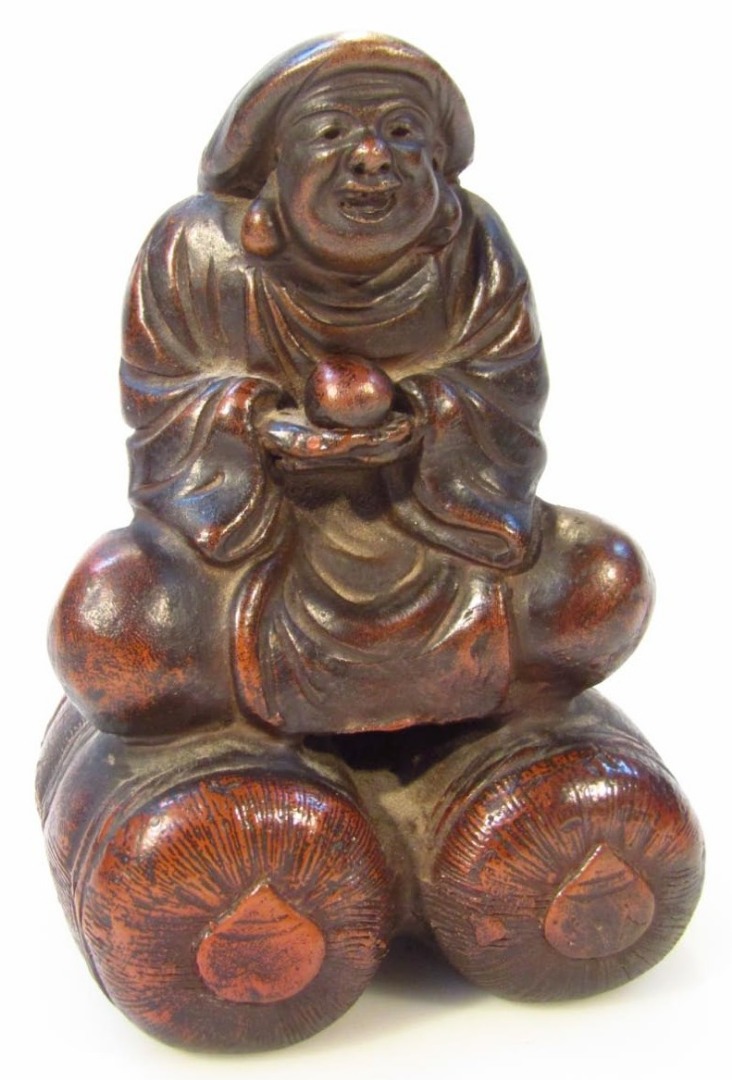 Appraisal: A Chinese figure group of a seated Buddah in flowing