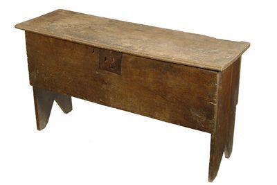 Appraisal: A Charles II oak boarded chest on cut out ends