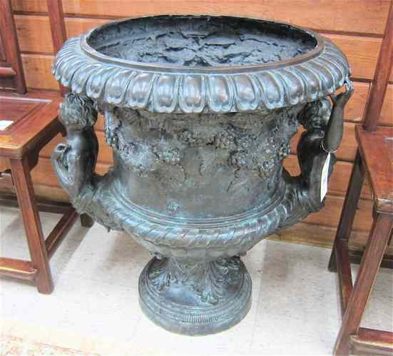 Appraisal: BRONZE FLOOR URN of footed campana design the sides decorated