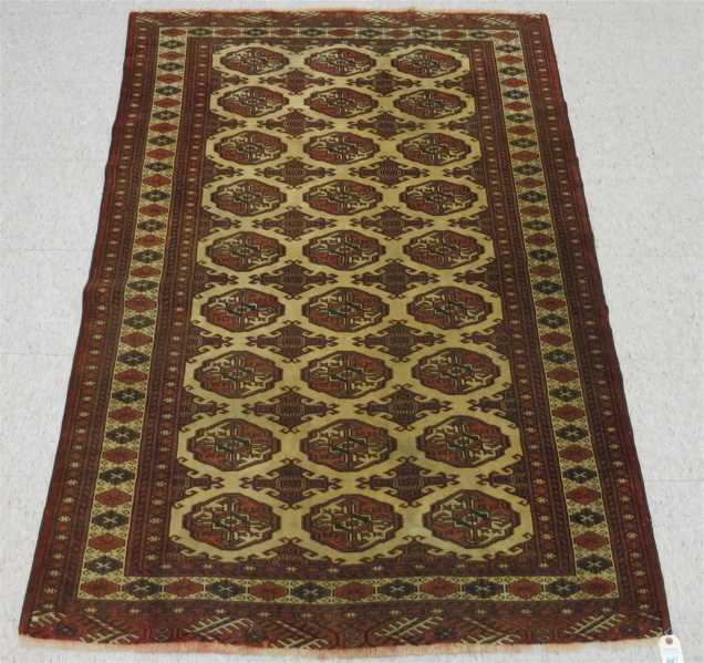 Appraisal: SEMI-ANTIQUE TURKOMAN BOKHARA AREA RUG featuring a field of geometric