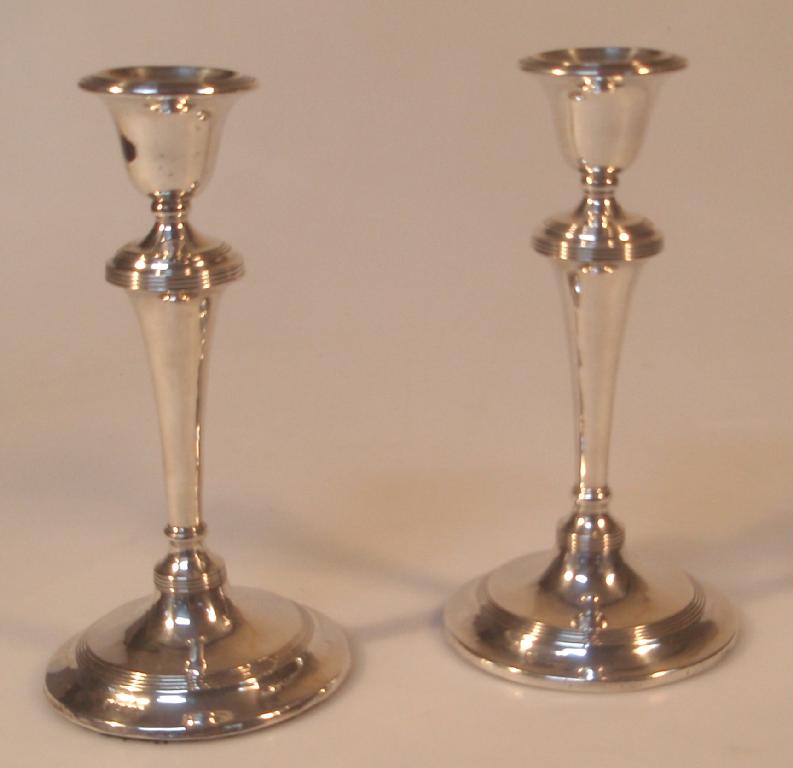 Appraisal: A pair of Edwardian silver candlesticks with annulated decoration maker