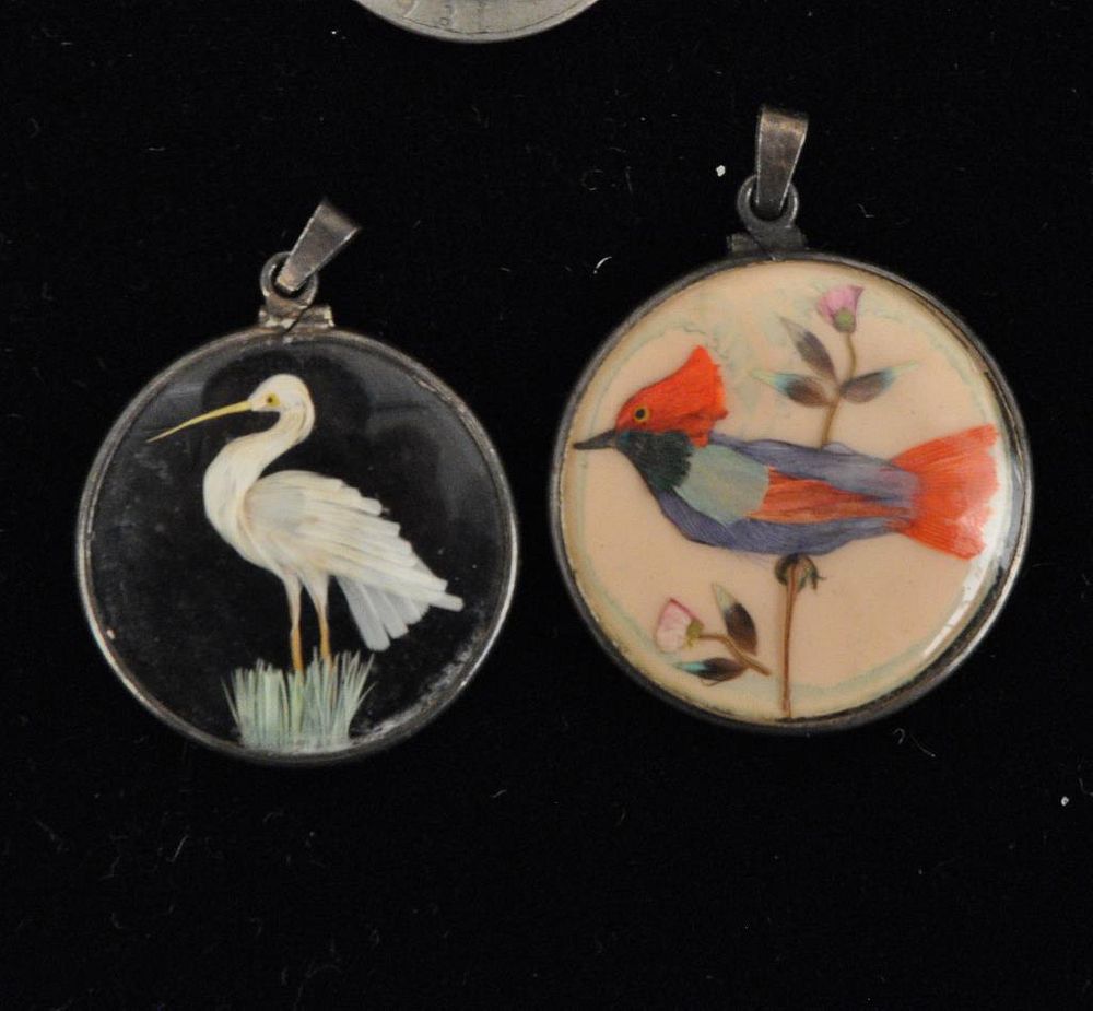 Appraisal: Two Antique Double Sided Feather Bird Pendants the largest diameter