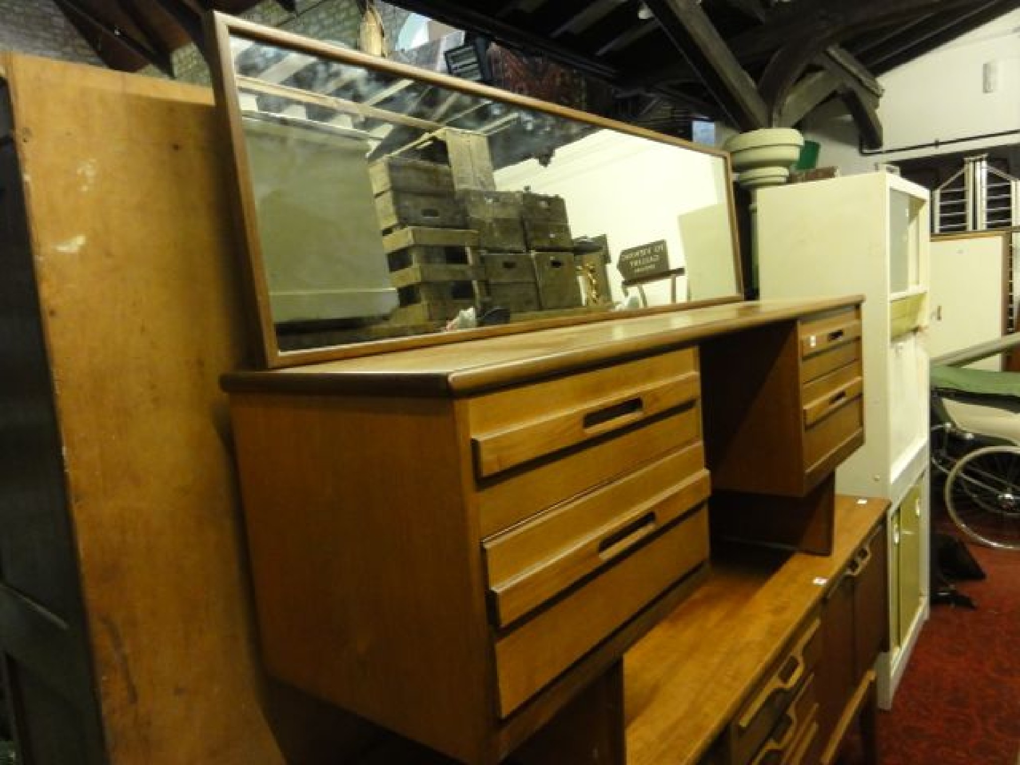 Appraisal: A long low mid- th century teak kneehole dressing table