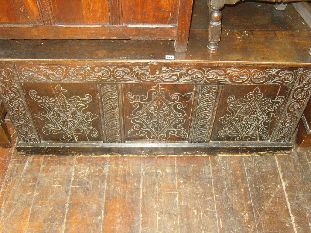 Appraisal: A Georgian oak coffer with panelled frame and carved front