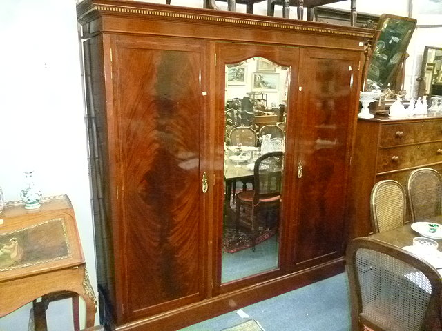 Appraisal: A LATE VICTORIAN MAHOGANY TRIPLE WARDROBE the central mirrored door