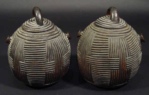 Appraisal: Two hardwood tribal art storage canisters and covers with geometric