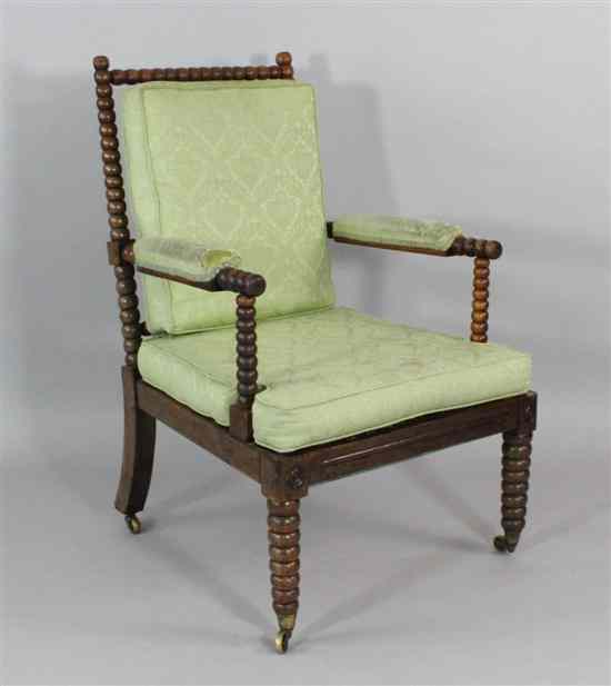 Appraisal: A Regency bobbin turned stained oak elbow chair with green