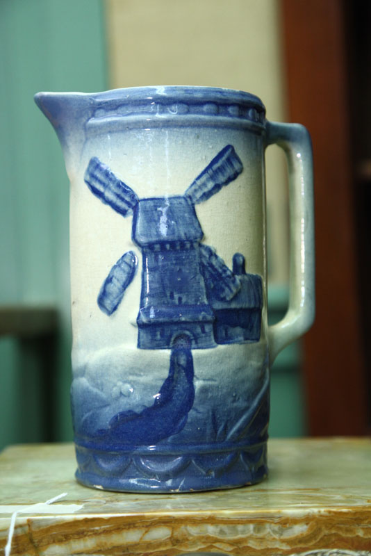 Appraisal: KITCHEN STONEWARE PITCHER Blue and white with windmill decoration ''h