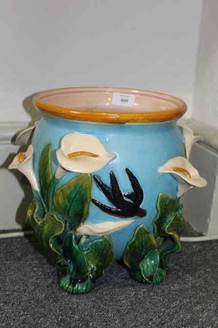 Appraisal: A MAJOLICA TURQUOISE JARDINIERE on a green leaf base high