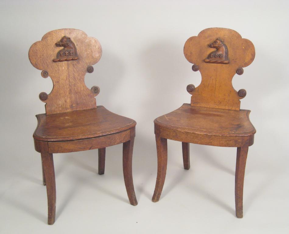 Appraisal: Pair of th Century oak Hall Chairs with solid splats