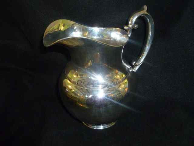 Appraisal: AN AMERICAN SILVER JUG OF BALUSTER FORM with scroll work