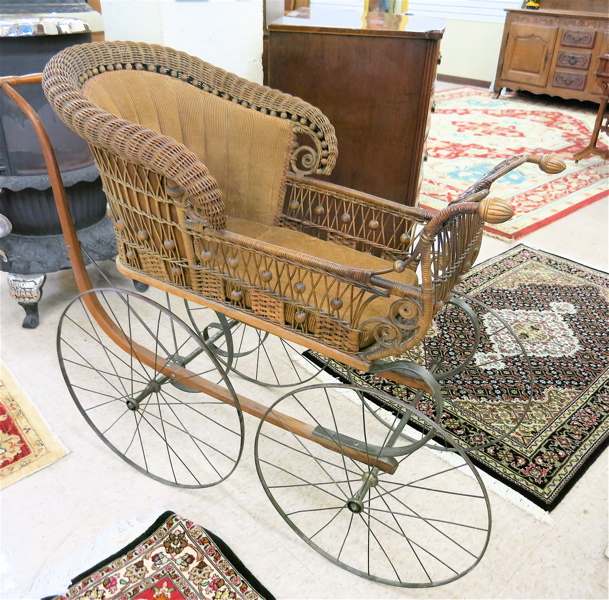 Appraisal: EARLY MODEL RATTAN BABY CARRIAGE Home Rattan Company Chicago established