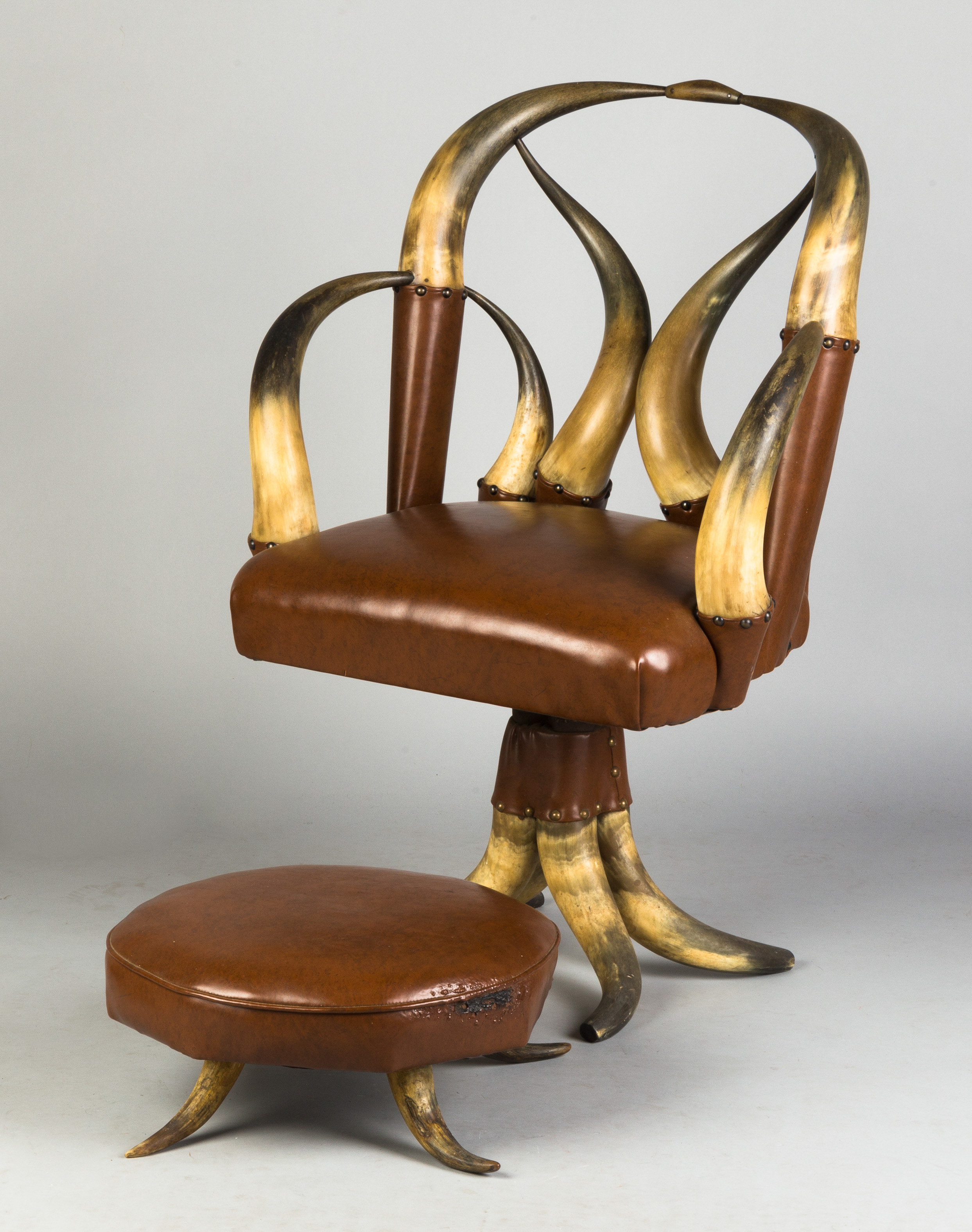 Appraisal: Swivel Horn Chair with Matching Footstool Early th century Brown