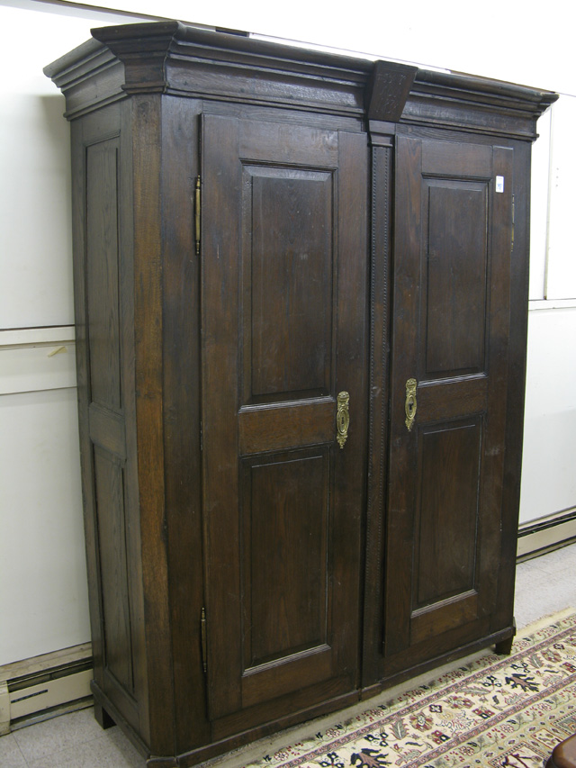 Appraisal: AN OAK DOUBLE-DOOR WARDROBE Continental dated having two full-length panel