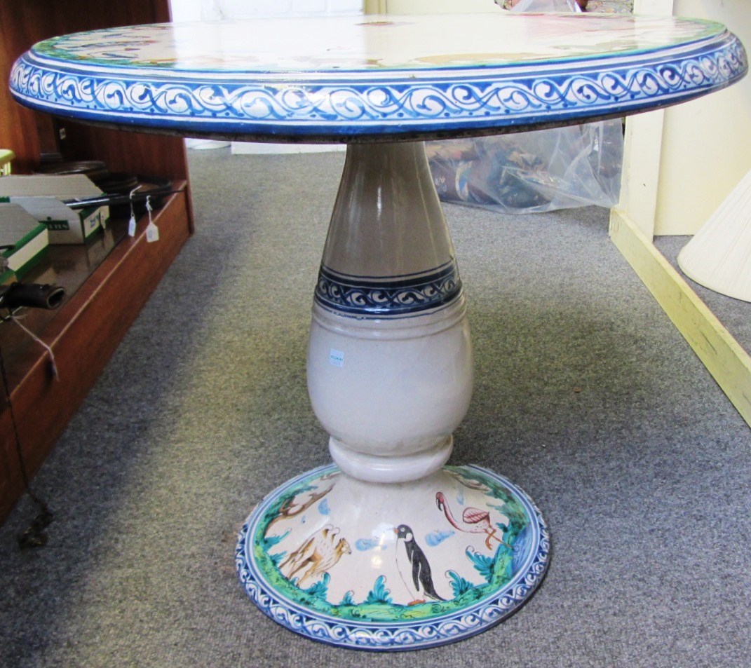 Appraisal: A Continental pottery garden table the tin glaze circular top