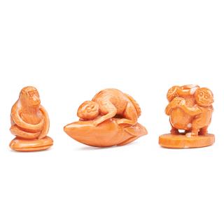 Appraisal: CARVED CORAL FIGURES Three Seated monkey rat clutching a flower