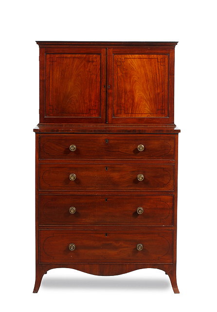 Appraisal: A REGENCY MAHOGANY CABINET CHEST the twin panelled cupboard doors