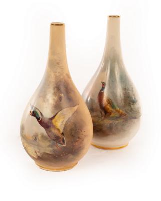 Appraisal: Two Royal Worcester pear-shaped vases with gilt rimmed narrow necks