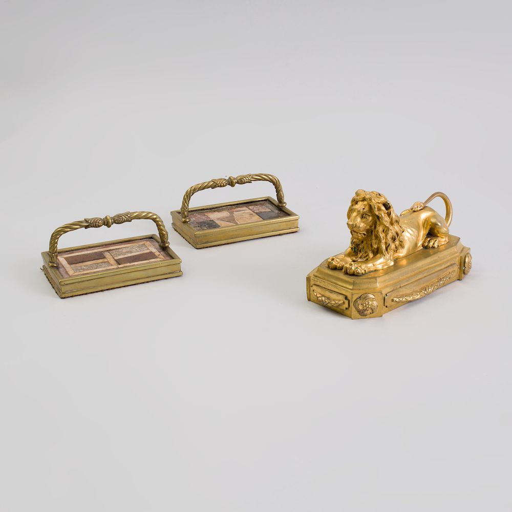 Appraisal: Regency Gilt Bronze Lion-Form Paperweight and a Pair of Gilt-Metal-Mounted