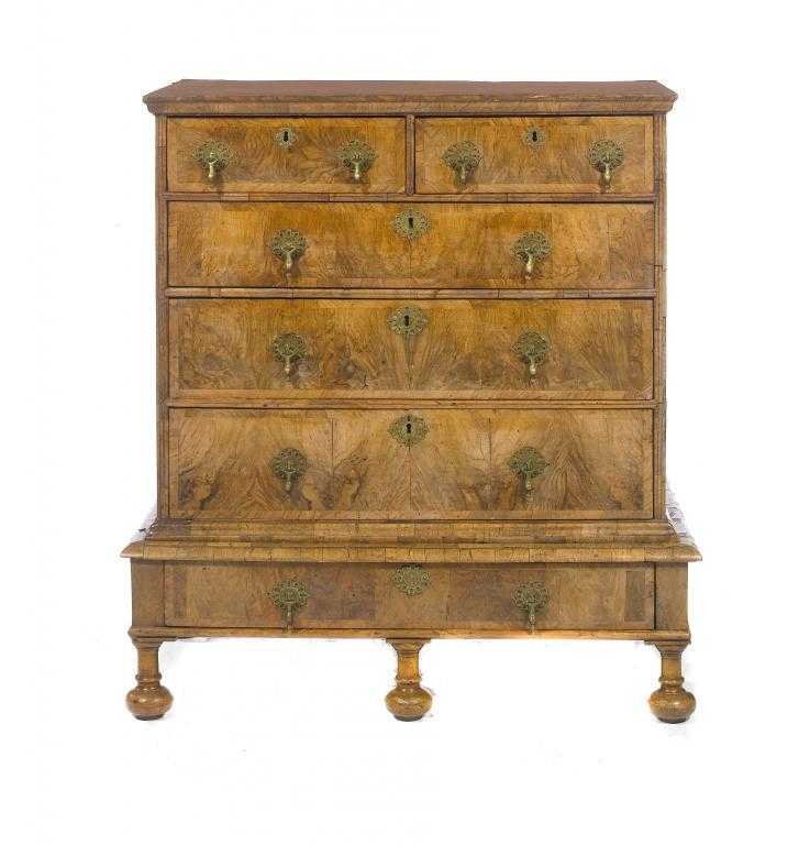 Appraisal: A WILLIAM III WALNUT AND FEATHERBANDED CHEST-ON-STAND with moulded top