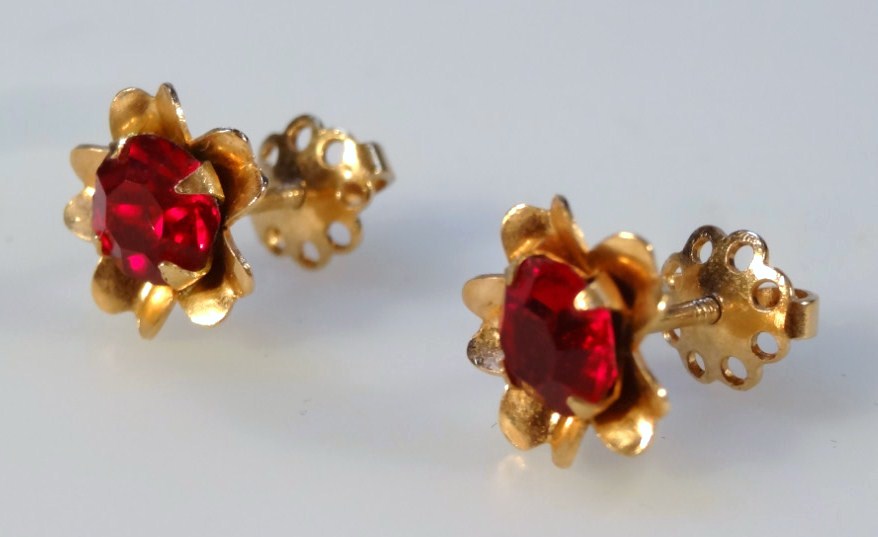 Appraisal: A pair of floral ear studs each set with red