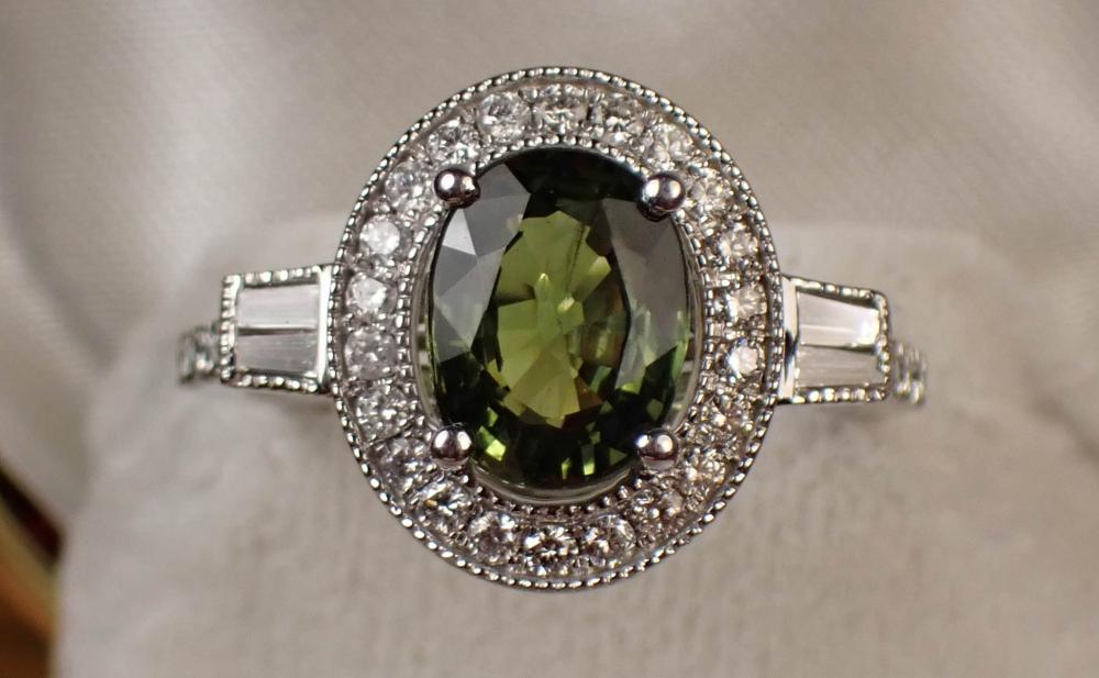 Appraisal: GREEN SAPPHIRE DIAMOND AND PLATINUM RING with round and baguette