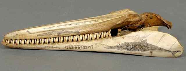 Appraisal: Scrimshaw porpoise jaw with carved harpoon and sea life designs