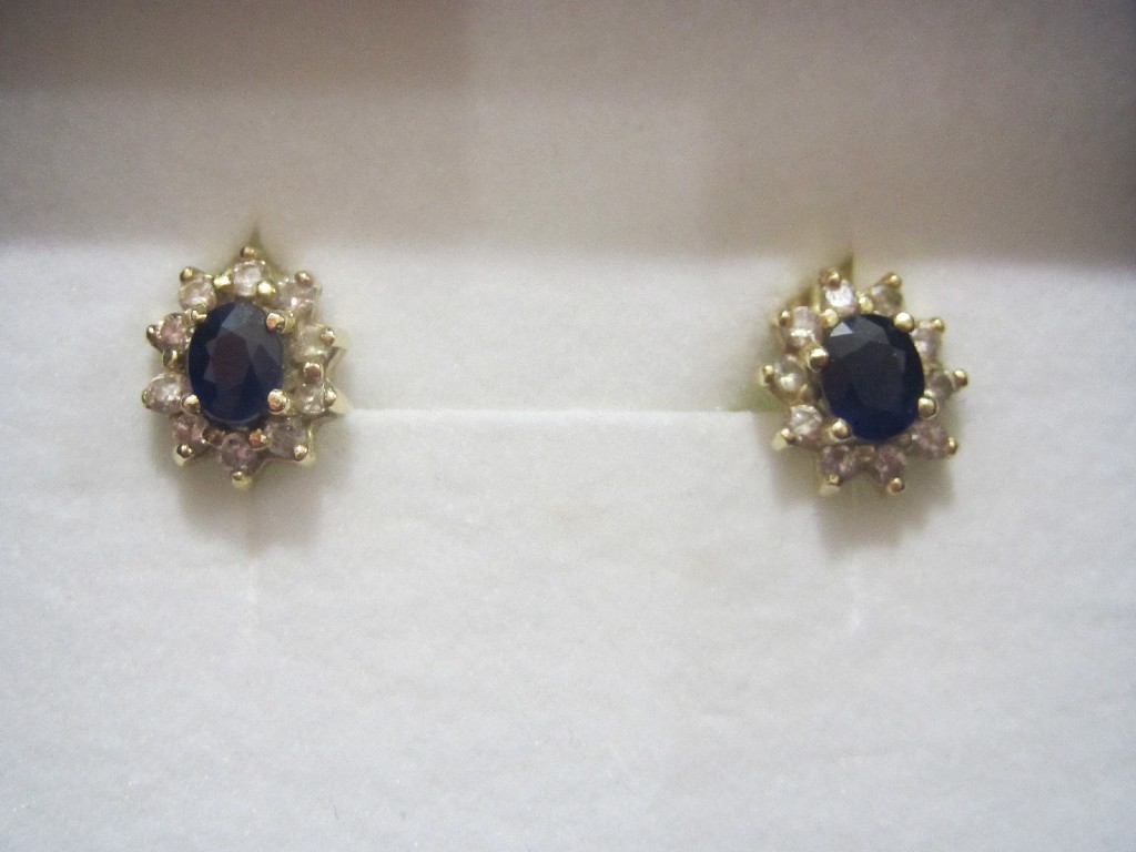 Appraisal: Eighteen carat gold sapphire and diamond cluster stud earrings