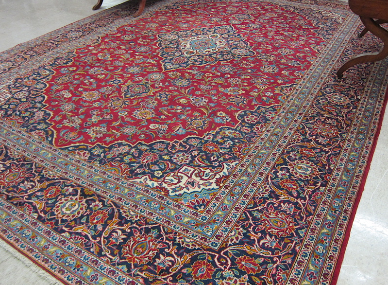 Appraisal: PERSIAN KASHAN CARPET floral and central floral medallion design on