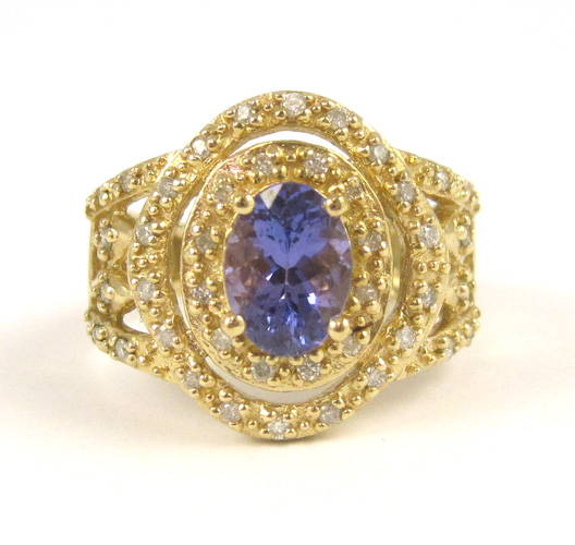 Appraisal: TANZANITE DIAMOND AND FOURTEEN KARAT GOLD RING with round-cut diamonds