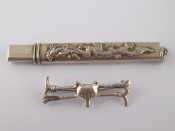 Appraisal: A Chinese white metal pencil case with suspensory loop and