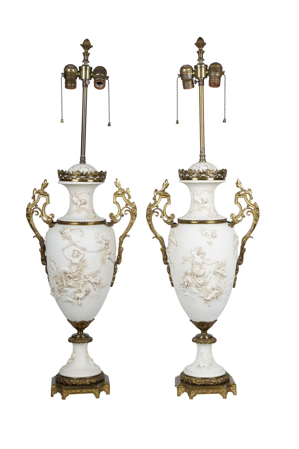 Appraisal: PAIR OF BISQUE PORCELAIN URNSmounted and electrified as table lamps