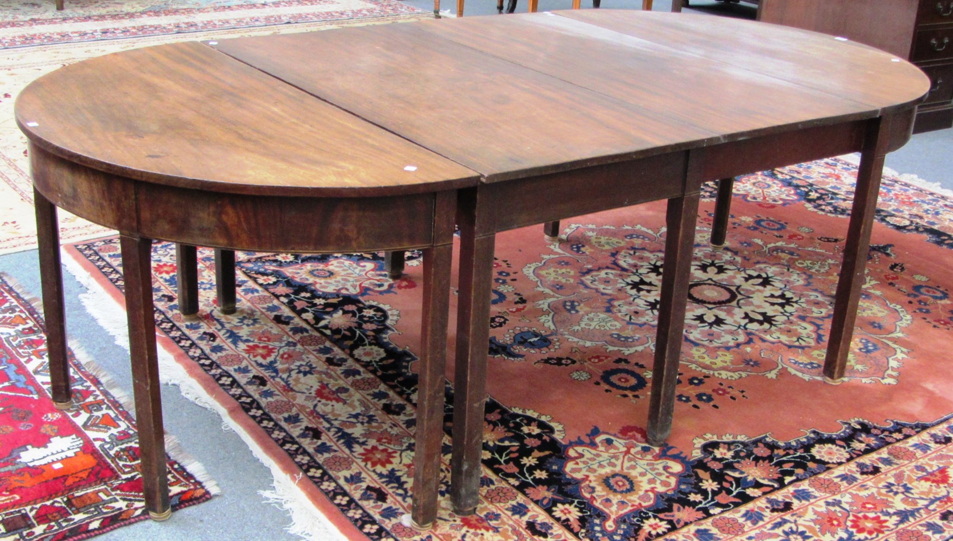 Appraisal: A George III mahogany D-end extending dining table with rectangular