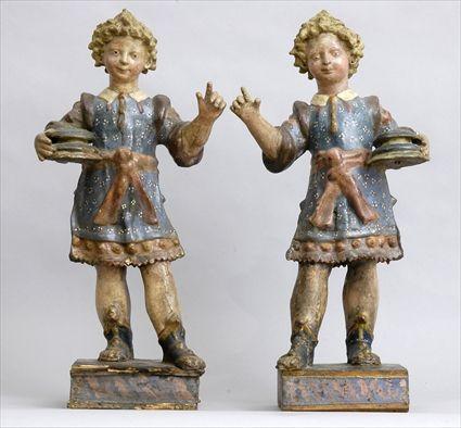 Appraisal: PAIR OF CONTINENTAL BAROQUE CARVED AND PAINTED FIGURAL CANDLE HOLDERS