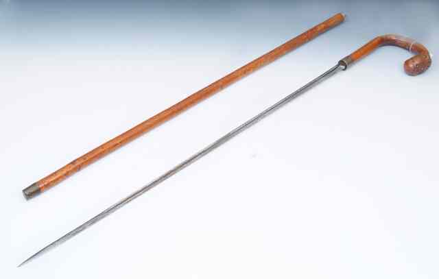 Appraisal: A BAMBOO AND ROOT HANDLED SWORD STICK with silver collar