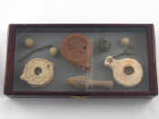 Appraisal: A display case of ten Roman artefacts including three lamps