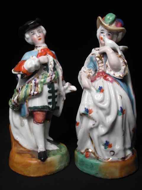 Appraisal: Pair of two pottery figurines th century depicting a lady