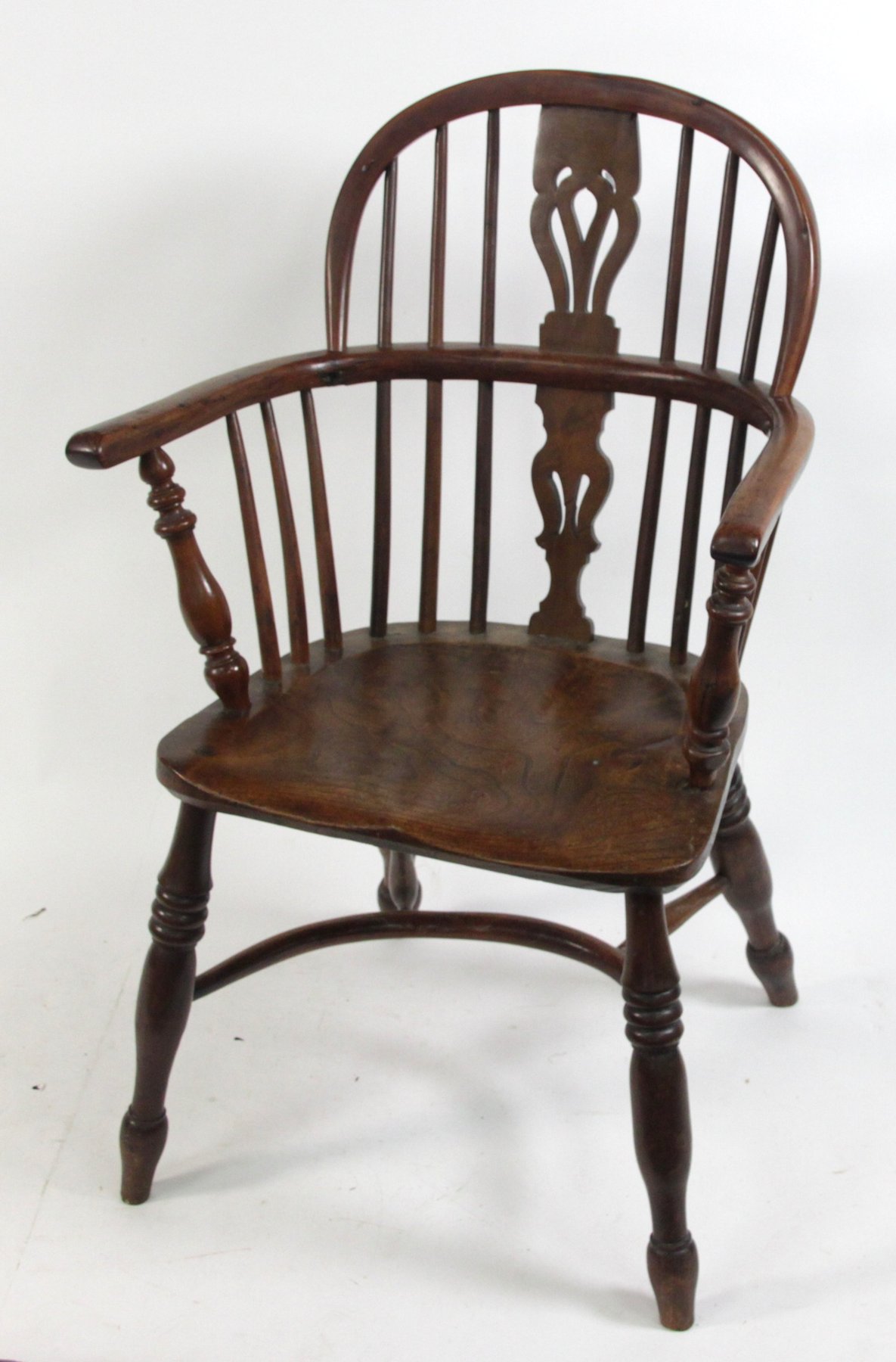 Appraisal: A yew wood and elm Windsor armchair with pierced splat