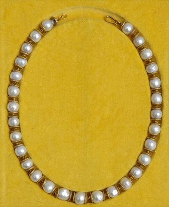 Appraisal: GOLD AND PEARL NECKLACE Strand of white baroque pearls with