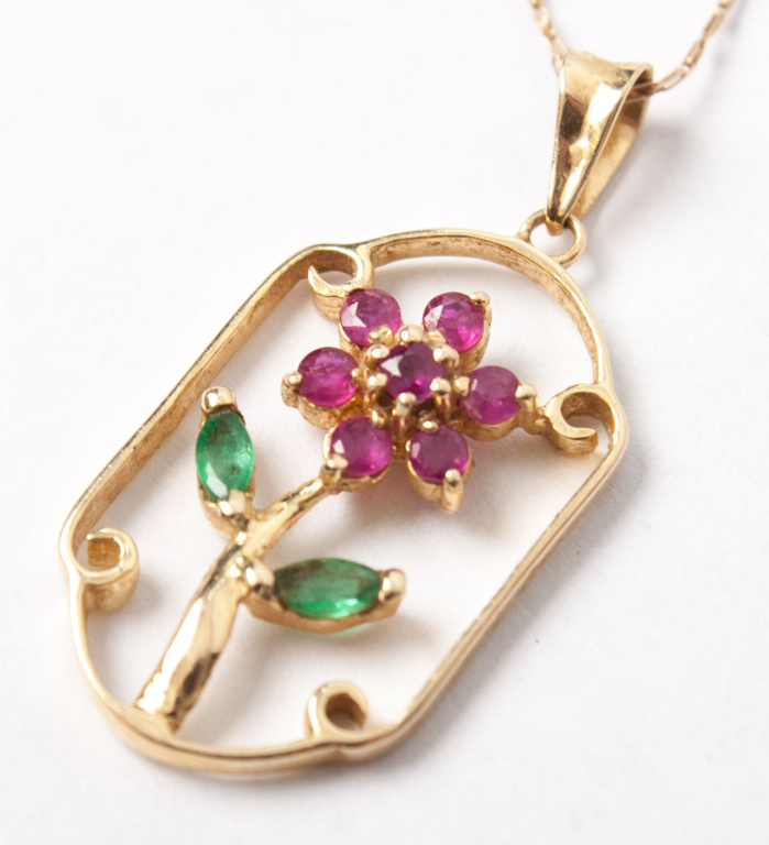 Appraisal: K gold ruby emerald flower-form pendant about in L on