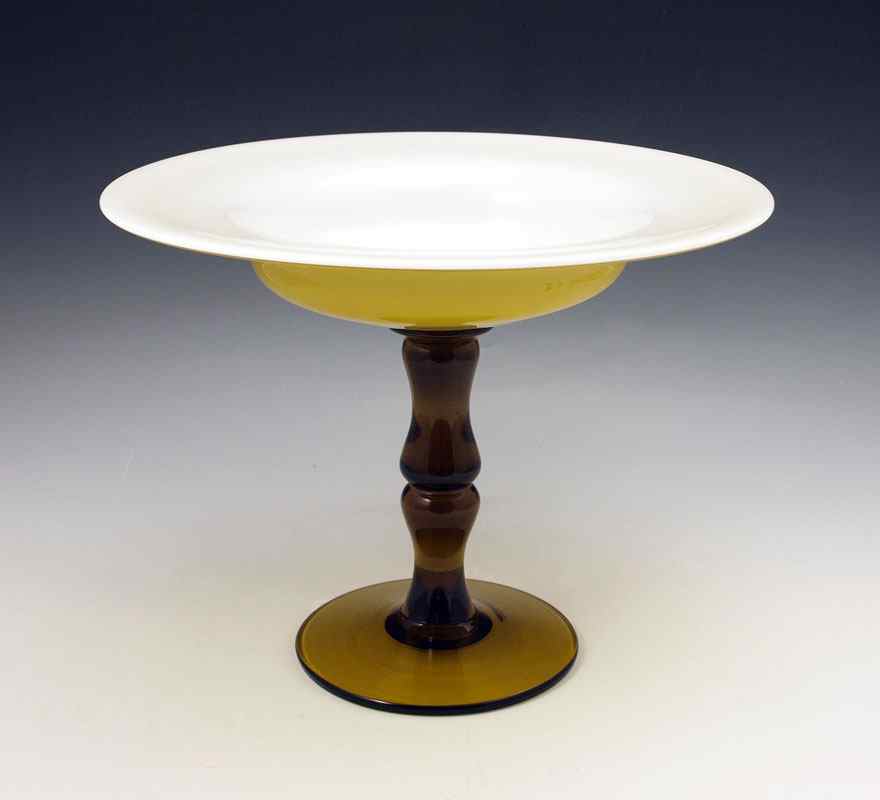 Appraisal: AMBER AND ALABASTER GLASS COMPOTE Alabaster cased amber bowl on