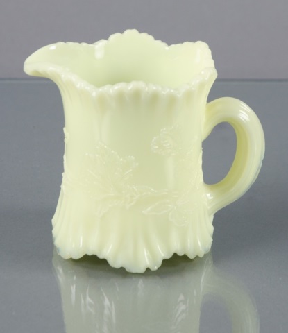 Appraisal: Northwood Custard Glass CreamerHaving applied pouring handle Scalloped rim and