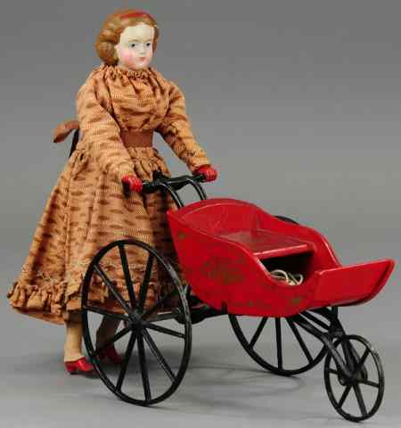 Appraisal: GOODWIN GIRL PUSHING DOLL CARRIAGE Pat open wood doll carriage