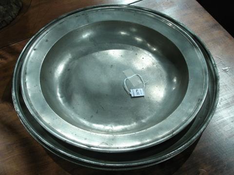 Appraisal: FOUR LARGE PEWTER SERVING DISHES The first having slightly dished